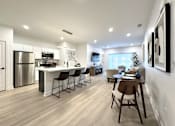 Thumbnail 2 of 22 - View of typical kitchen and great room area from the front entrance hallway