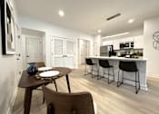 Thumbnail 5 of 22 - Typical great room dining & kitchen area with breakfast bar and stainless steel appliances