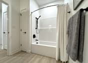 Thumbnail 11 of 22 - Typical second bathroom with tub/shower combo and linen closet