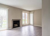 Thumbnail 6 of 20 - View of great room from dining area showing fireplace, faux-wood flooring, and slider to patio