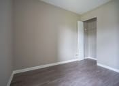 Thumbnail 10 of 20 - View of typical second bedroom with closet and faux plank flooring