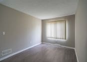 Thumbnail 7 of 20 - View of typical primary bedroom with large windows and faux plank flooring