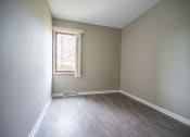 Thumbnail 8 of 20 - View of typical second bedroom with window and faux plank flooring