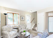 Thumbnail 2 of 32 - Townhome great room view of living area and front entrance, stairs to second floor and entrance to kitchen