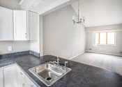 Thumbnail 12 of 32 - an empty kitchen and living room with a sink