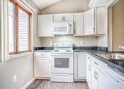 Thumbnail 7 of 32 - a kitchen with white appliances and white cabinets