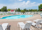 Thumbnail 1 of 27 - Pool and Pool Deck with Lounge Chairs & Tables