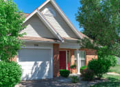 Thumbnail 21 of 27 - Exterior view of ranch end unit with private covered entrance & attached 1-car garage
