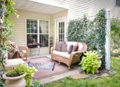 Thumbnail 12 of 27 - Exterior view of private patio with comfortable seating & decorative plants