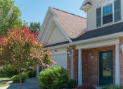 Thumbnail 20 of 27 - Exterior view of covered private entrance porch and attached 1-car garage at Webster Woods