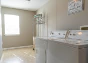 Thumbnail 11 of 27 - Interior view of large laundry room with full size washer & dryer