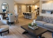 Thumbnail 5 of 22 - Interior of Champion Reserve Townhome Great Room showing living area, dining area, coffee bar, and kitchen area with breakfast bar.
