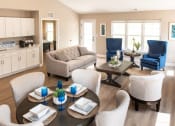 Thumbnail 7 of 22 - Interior of Champion Reserve Townhome Great Room showing living area, dining area, coffee bar, and doors to private patio and primary bedroom.