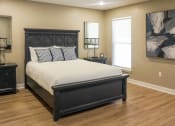 Thumbnail 11 of 22 - Interior of Champion Reserve Townhome primary bedroom with faux wood flooring.