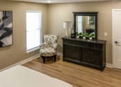 Thumbnail 12 of 22 - Interior of Champion Reserve Townhome primary bedroom with faux wood flooring.
