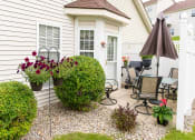 Thumbnail 26 of 31 - a backyard patio with a table and chairs and an umbrella