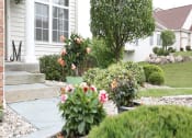 Thumbnail 27 of 31 - the front yard of a white house with flowers in the garden