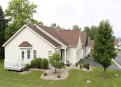Thumbnail 30 of 31 - a row of white houses with a yard and trees