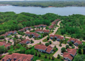 Thumbnail 24 of 31 - an aerial view of a neighborhood with a body of water