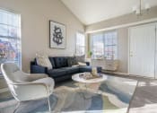 Thumbnail 3 of 31 - a living room with a couch and chairs and a table