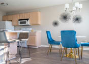 Thumbnail 9 of 31 - a kitchen and dining room with a table and chairs