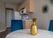 Thumbnail 12 of 31 - a dining room table with a gold vase on it
