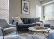 Thumbnail 5 of 31 - a living room with a blue couch and a coffee table