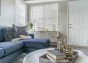 Thumbnail 6 of 31 - a living room with a blue couch and a table with books