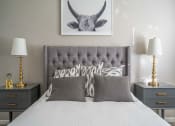 Thumbnail 14 of 31 - a bedroom with a bed and a picture of a bull