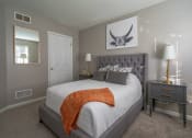 Thumbnail 13 of 31 - a bedroom with a large bed and a mirror