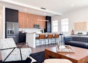Thumbnail 2 of 29 - A modern kitchen with a black and white chair.