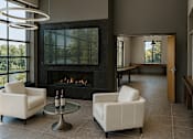 Thumbnail 24 of 29 - Artist rendering of the interior of the Community Center with fireplace, flat screen TV, gathering areas, and view overlooking the Erie Canal