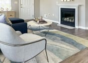 Thumbnail 1 of 31 - View of living area in ranch townhome great room with fireplace, cathedral ceiling, and faux hardwood floors
