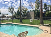Thumbnail 5 of 8 - a swimming pool with chairs next to a fence