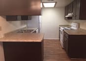 Thumbnail 8 of 8 - an empty kitchen with a stove and a sink