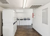 Thumbnail 42 of 42 - A white kitchen with a white fridge and white oven.