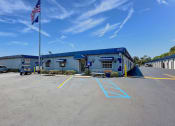Thumbnail 1 of 29 - an empty parking lot in front of the HEG office building with an american flag