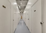 Thumbnail 21 of 29 - a row of white lockers in a prison hallway