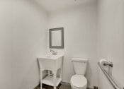Thumbnail 23 of 29 - a small bathroom with a toilet and a sink