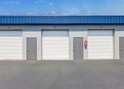 Thumbnail 5 of 29 - a row of garage doors on the side of a building