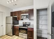 Thumbnail 15 of 60 - A kitchen with a refrigerator, oven, and microwave at Venue at 109 Apartments, Tennessee, 37090