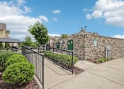 Thumbnail 45 of 60 - A stone building with a green sign on it at Venue at 109 Apartments, Lebanon , TN, 37090