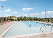 Thumbnail 40 of 60 - A large outdoor swimming pool with a metal ladder on the side at Venue at 109 Apartments, Lebanon  37090