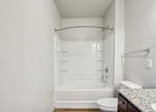 Thumbnail 19 of 60 - A white bathroom with a toilet, sink, and bathtub at Venue at 109 Apartments, Lebanon , Tennessee