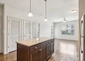 Thumbnail 9 of 60 - A kitchen with a granite countertop and wooden cabinets at Venue at 109 Apartments, Lebanon , TN, 37090