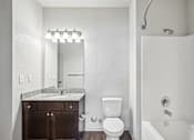 Thumbnail 2 of 60 - A white bathroom with a toilet, sink, and a mirror at Venue at 109 Apartments, Lebanon , TN, 37090