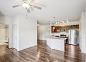 Thumbnail 22 of 60 - A kitchen with a white island and a ceiling fan at Venue at 109 Apartments, Tennessee