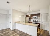 Thumbnail 3 of 60 - A kitchen with a granite countertop and stainless steel appliances. at Venue at 109 Apartments, Lebanon , TN