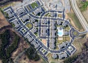 Thumbnail 57 of 60 - A bird's eye view of a residential area with a roundabout in the center. at Venue at 109 Apartments, Lebanon 