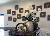 Thumbnail 5 of 10 - A wicker basket with a vase of flowers and eggs inside.